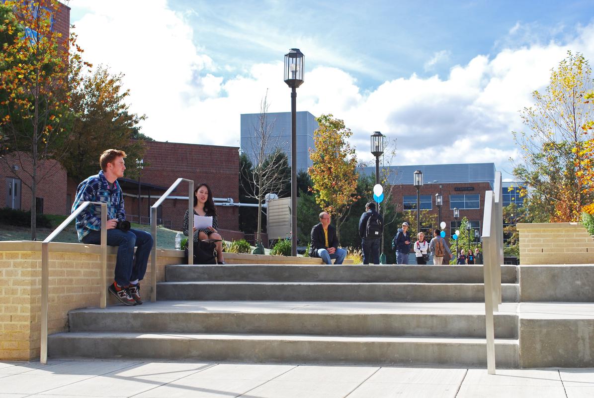 students sitting on campus steps