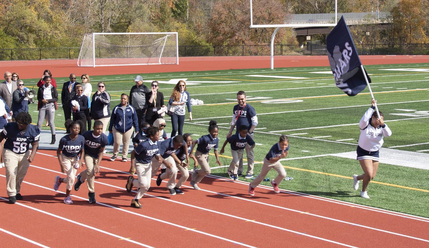 youth running the track at KIPP campus stadium in Columbus