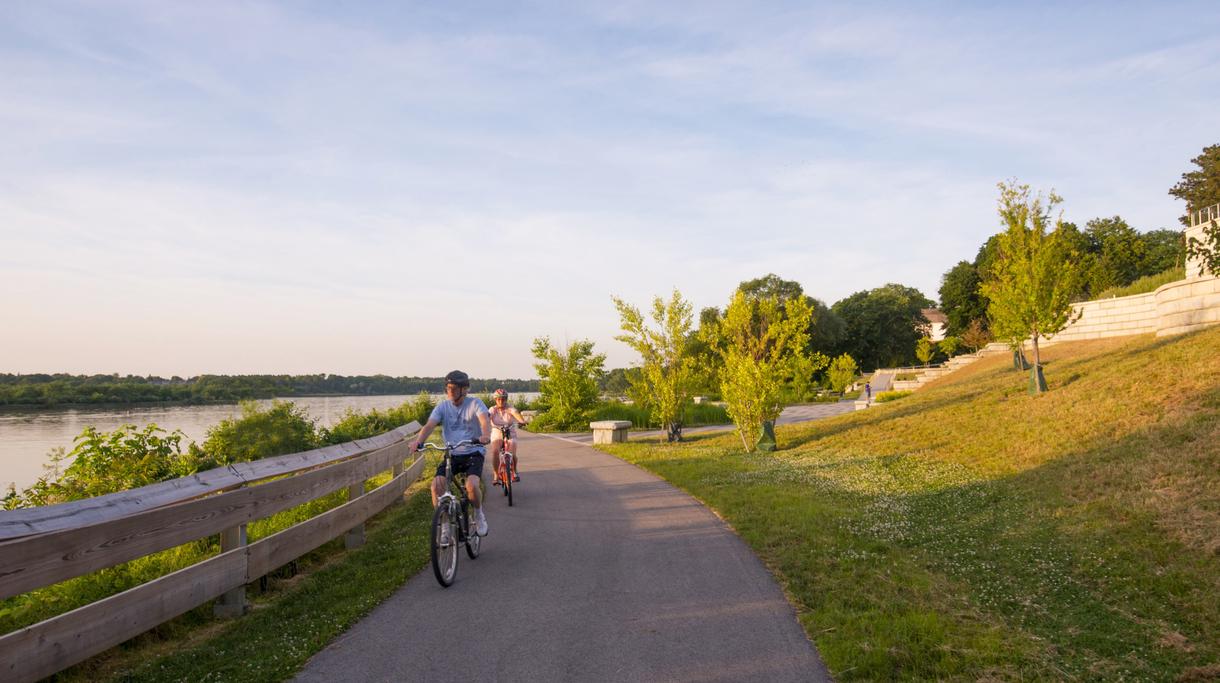 Family biking along the path at Perrysburg Riverside Park. 