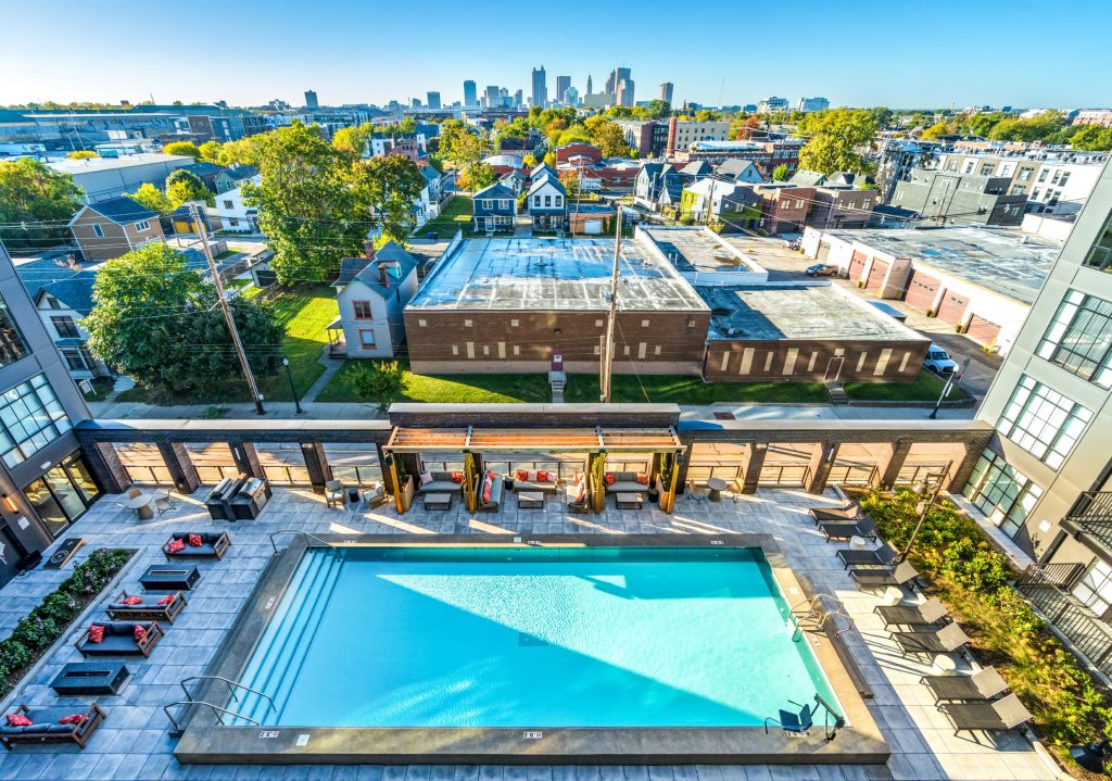 Rooftop deck with pool, shaded cabanas, and lounge seating overlooking Columbus skyline.